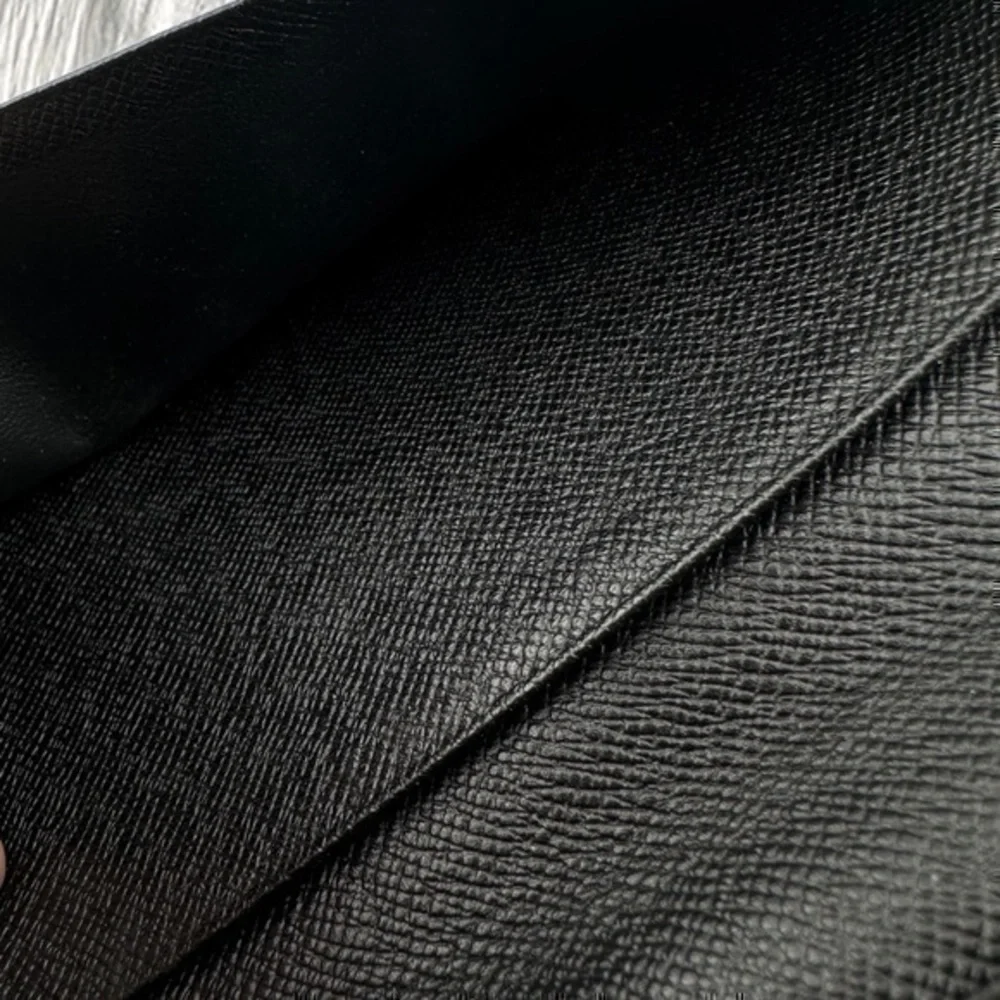 AUTHENTIC Louis Vuitton Taiga wallet. Previously owned. Color: Black.